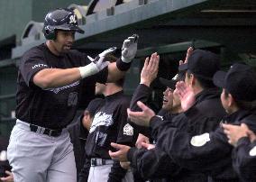 May greeted by teammates after homer against Seibu